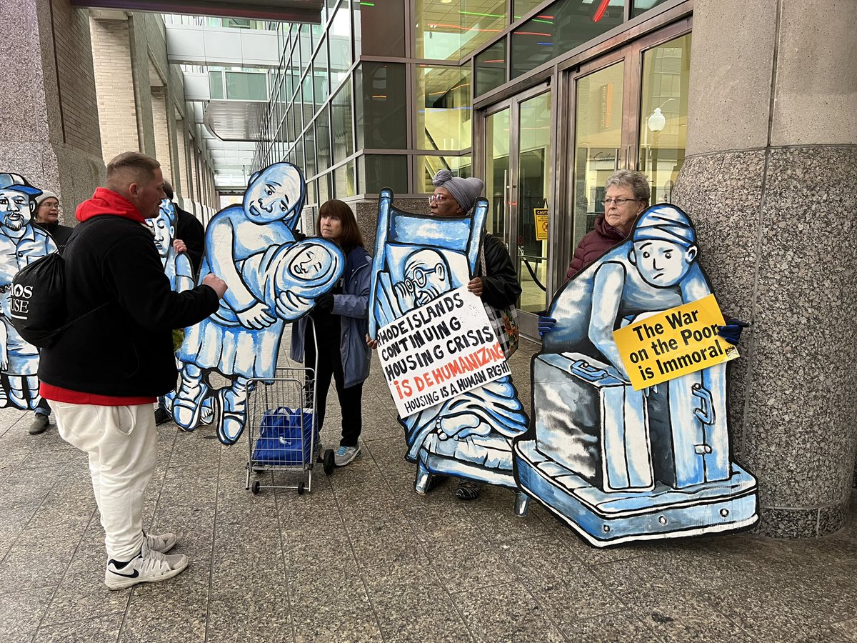 steveahlquist's tweet photo. Outside @GovDanMcKee’s inauguration, advocates for the unhoused and the unhoused themselves are holding signs as a silent indictment on the Governor’s inaction on homelessness, and on the actions of the Governor in clearing homeless encampments. https://t.co/x8kTrrZdpl