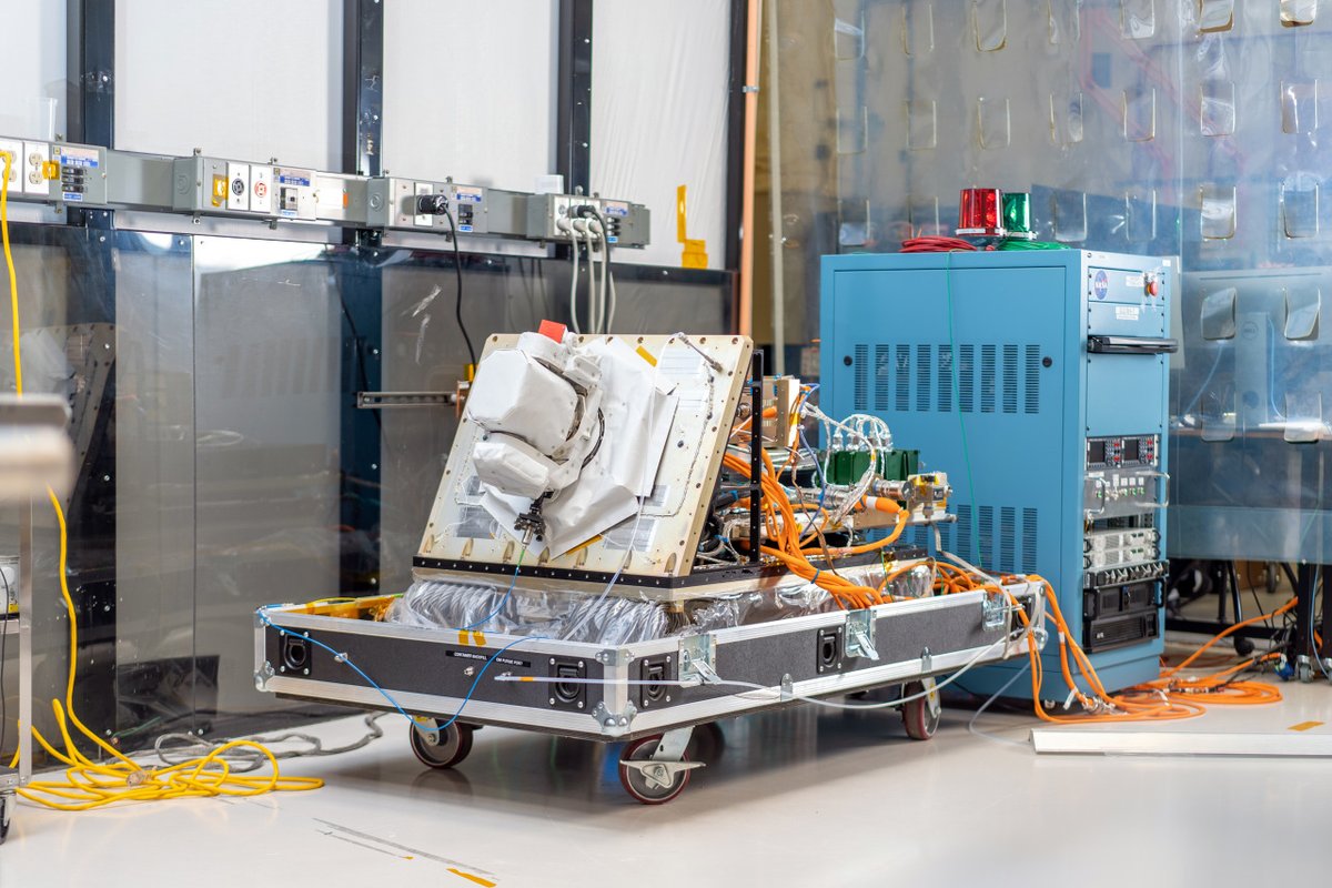 The ILLUMA-T payload in a Goddard cleanroom with a covered optical module and various wires and simulators. Credit: NASA/Taylor Mickal