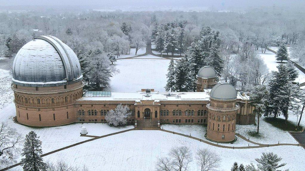 Yerkes Observatory domes, building and Olmsted-designed grounds covered in a dusting of snow.