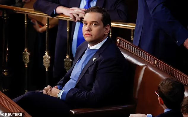 George Santos sits alone on the House floor with no one talking to him.