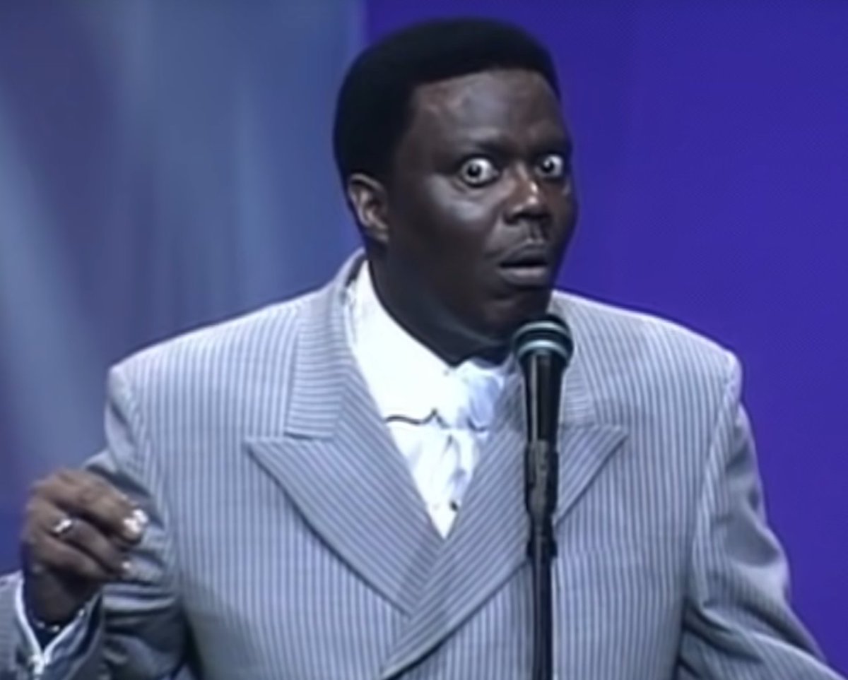 Computer, generate an image of Bernie Mac reacting to the dick girl ad from Cyberpunk 2077. Thank you
