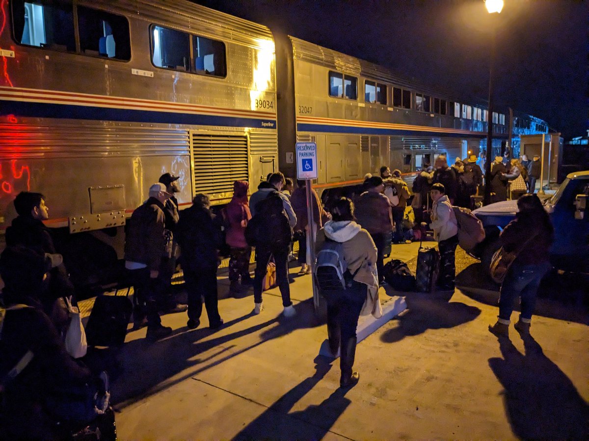 version2beta's tweet photo. Here we are standing outside of our replacement train in the cold waiting to board. And @Amtrak will board us once the bus fill of sleeper car passengers arrives. They were on later busses because they were served food before being crammed into a bus. https://t.co/6WiiuzdRLd