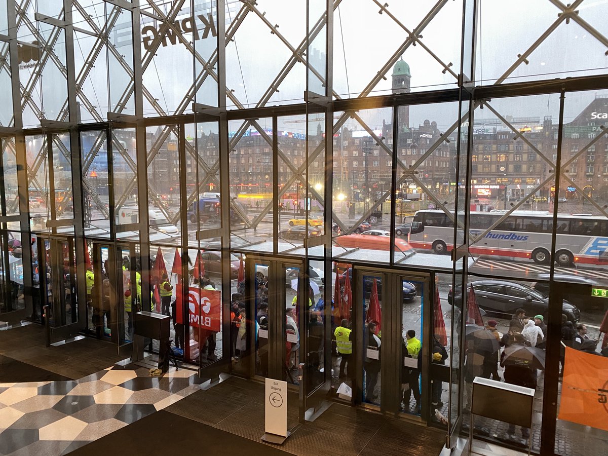 Røde faner foran ⁦<a href="/DanskIndustri/">DI - Dansk Industri</a>⁩ fra morgenstunden. Overenskomstforhandlingerne går i gang nu - også for ⁦<a href="/tmi_branche/">Træ- og Møbelindustrien</a>⁩ 200 medlemmer på træ- og møbeloverenskomsten #ok23