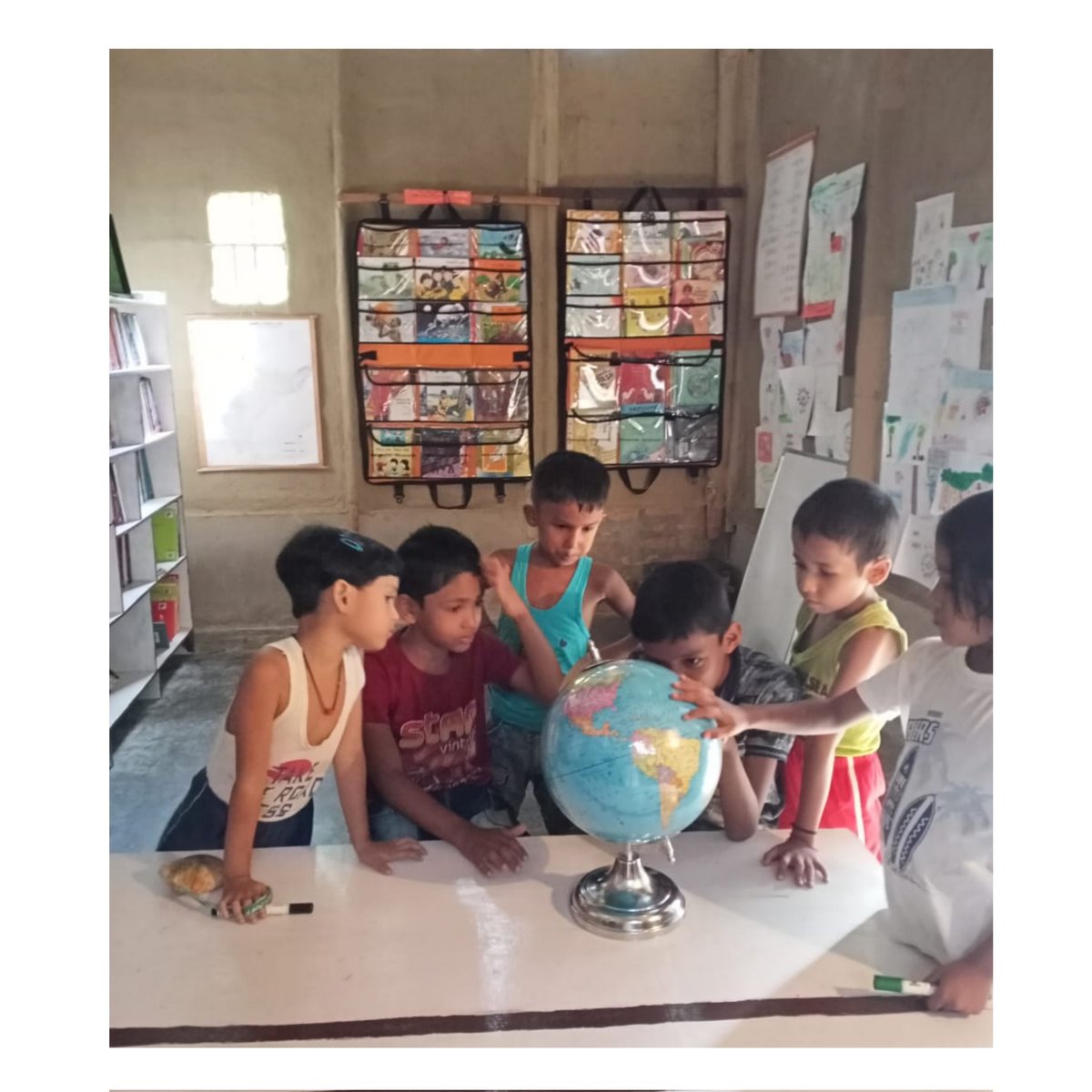 the_story_mama's tweet photo. Maina is joined by more friends from our village on the reading journey in our free library.
This was a moment of the curious case of a globe 🌎😆Because free library is fun. 
#freelibrary #reading #righttoread https://t.co/0nn7nr6qwJ