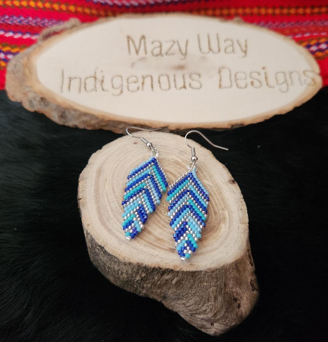 #HappyFridayyyyy 
Here is a pair of beaded earrings that resemble feathers to help the weekend fly in quickly!!
These can be custom made in any colour you like.  Shoot us a message to discuss your options!!  
#indigenousbeadwork #metisartist