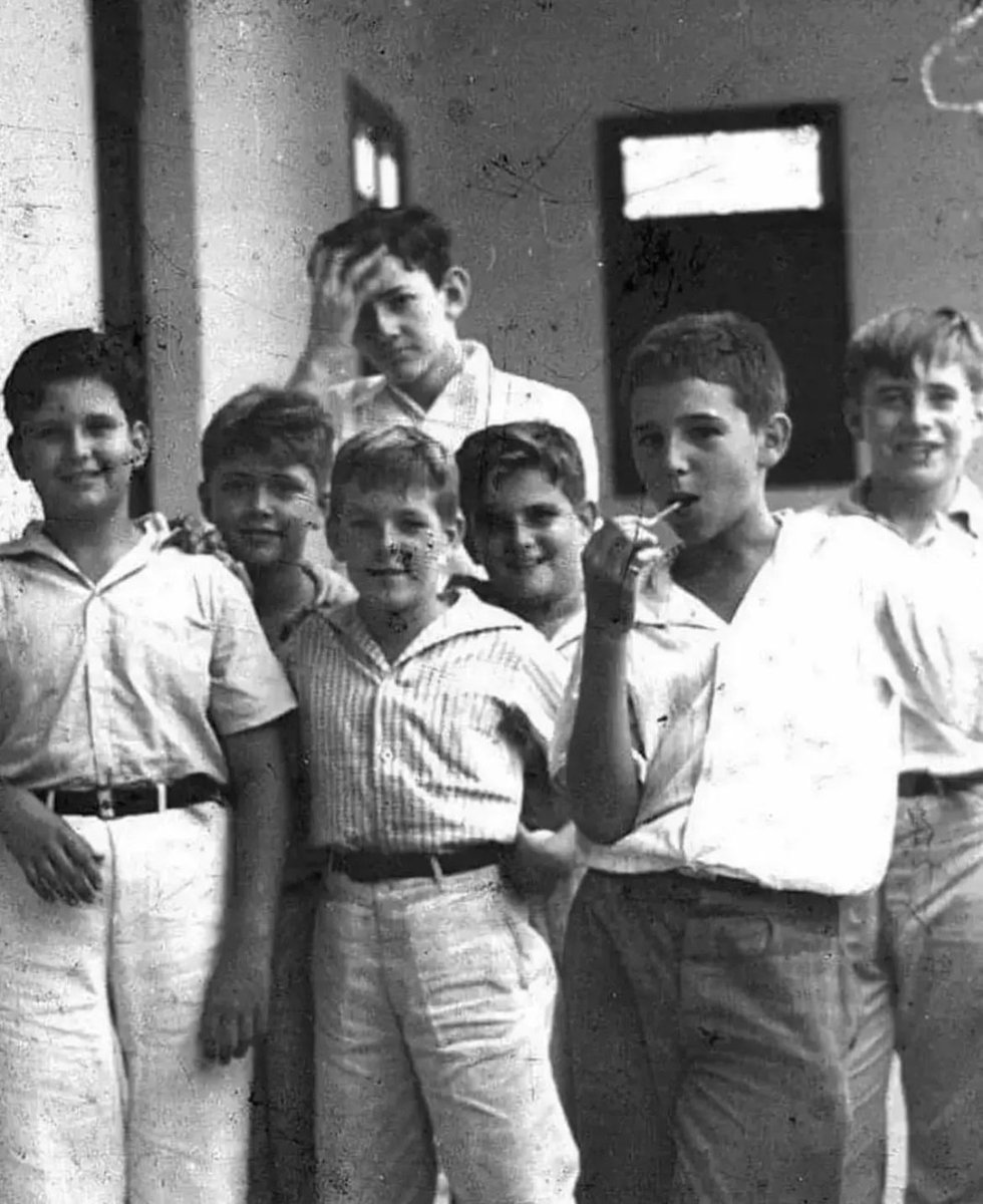 Fidel Castro eating a lollipop with his schoolmates at Nuestra Senora de Dolores school in Santiago, Cuba, 1937.