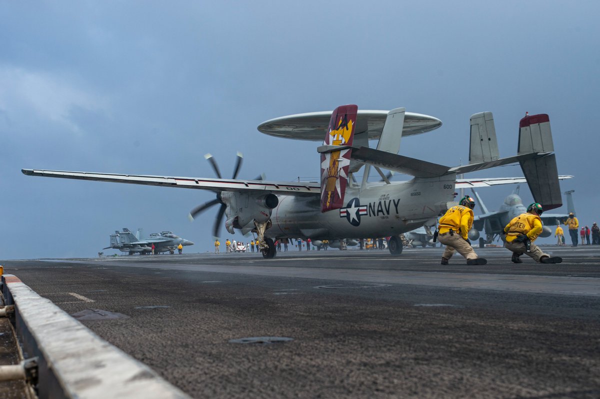 Aircraft of Carrier Air Wing 17 aboard USS #NIMITZ CVN68 during flying operations in the Philippine Sea on 5 Jan. The CAG F/A-18E of VFA137 touches down; F/A-18F of VFA-94 set for launch (3 Jan); F/A-18F of VFA-22 launches from the waist; E-2C of VAW-116 shoots from the waist