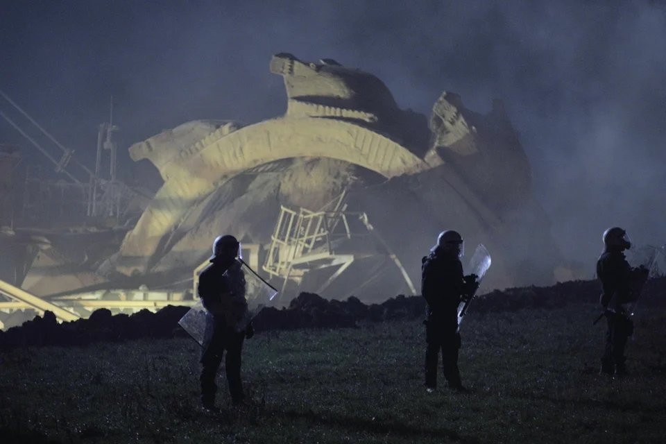 xr_cambridge's tweet photo. Police in Germany protecting a bucket wheel excavator from climate activists in Lützerath a village literally being razed to the ground for a coal mine. An image for our time https://t.co/v4BgGQeYzM