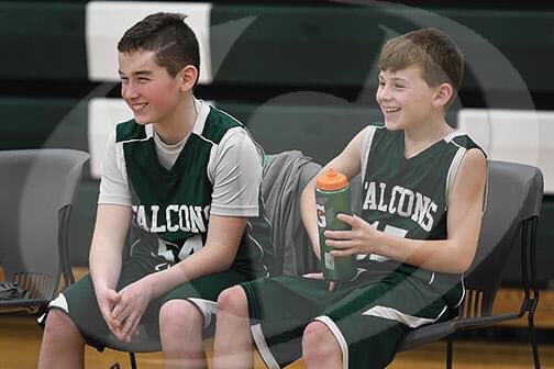 A really nice photo of Liam Doyle (6th grade) and Cody Feit (5th grade) on the bench. These two are in different schools, traditionally play opposite sports but here they are having fun and supporting their teammates.
(Photo Credit to George Skovera, Reminder Publishing)