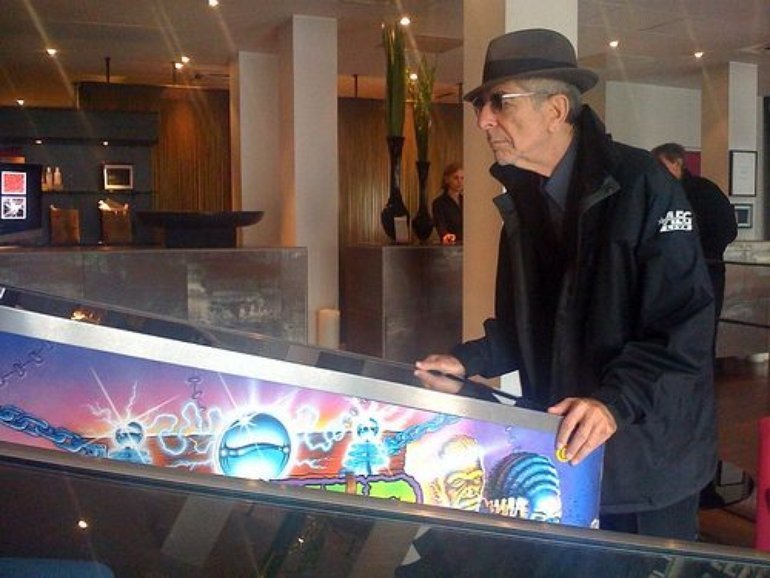 Leonard Cohen playing pinball.