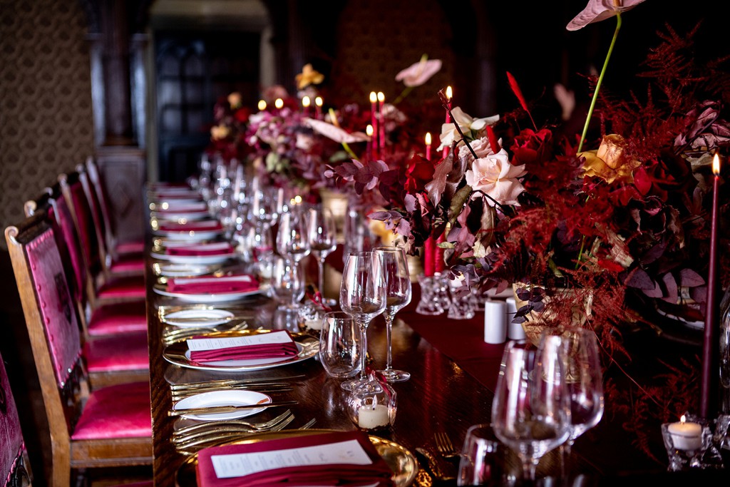 "One long dining table, deep reds, gold decor, and personalised glass bauble tealight holders that we bagged at the end of the night as gifts for guests to take home, with a boxed slice of wedding cake – it was all so romantic!" bit.ly/3W7mRdM

#IntimateWinterWedding