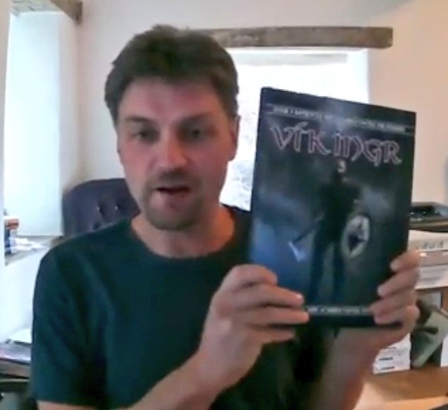rollspelspappan's tweet photo. Hang on a minute! Is Graham holding up a book with different cover art? I hadn't noticed that before - and I have watched that video many, many times! @ArionGames 

#rollspel #ttrpg #ttrpgs #VikingrRPG #OpenD6 https://t.co/IIbBVXB0hy