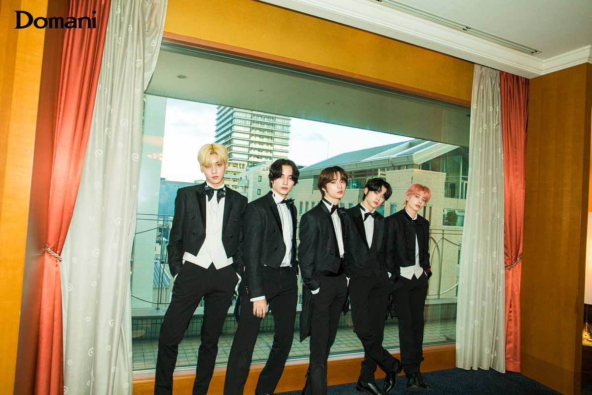 As the fifth of young men stood before the camera, impeccably attired in their black tuxedos, the atmosphere was one of refinement and sophistication. The occasion was their comeback interview for Domani Japan magazine, set to be published on the 21st of January on their website.