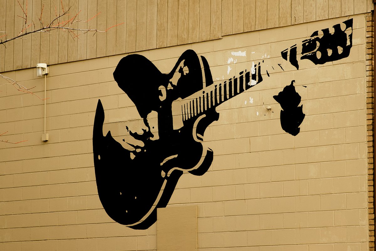 Guitar Town 
This is on the wall of the building next to the McLean County Arts Center. I just wanted to preserve it before it fades away.
#bloomingtonillinois #guitar