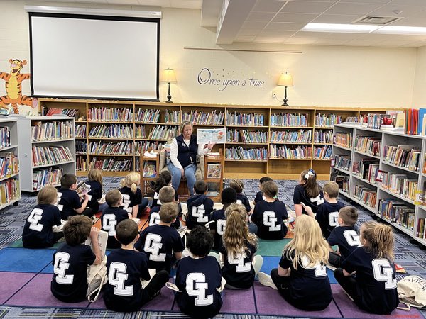 acoppGL's tweet image. Mrs. Koets' first graders being read to by Mrs. Ruge for library time while wearing the new class shirts! #gogulllake