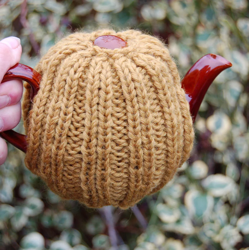 Yorkshireharec1's tweet photo. Hand Knitted Wool Tea cosy - to fit a small tea for teapot, knitted tea cosy - Ochre wool yarn https://t.co/2UAGMpP2Ba via @Etsy https://t.co/f4fYwoFPEI