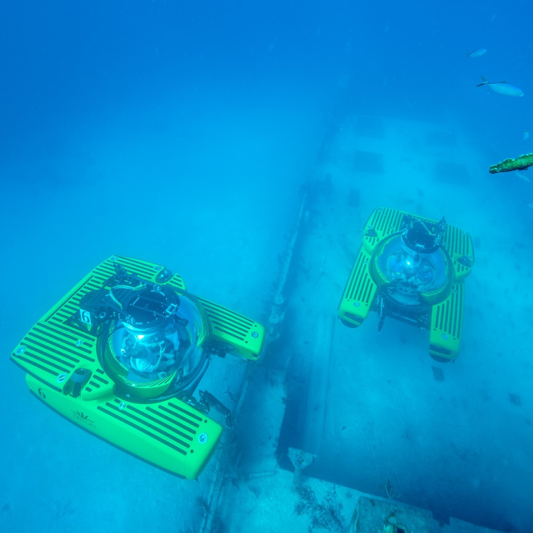 Ready to dive deep into the unknown, these Triton submersibles embark on a journey to explore the mysteries of a shallow shipwreck. With the capability to go much deeper (3,300 feet), who knows what treasures and stories they'll uncover on their underwater adventure?