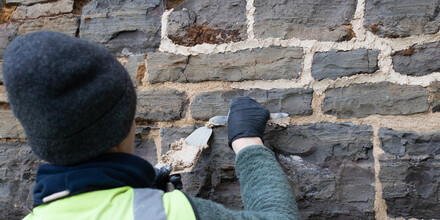 Did you know that churches need to breathe? Moisture needs to be able to enter and leave a building when the weather changes. Below is a picture of repointing being carried out with lime mortar one of the materials we use that better allow this process to happen.