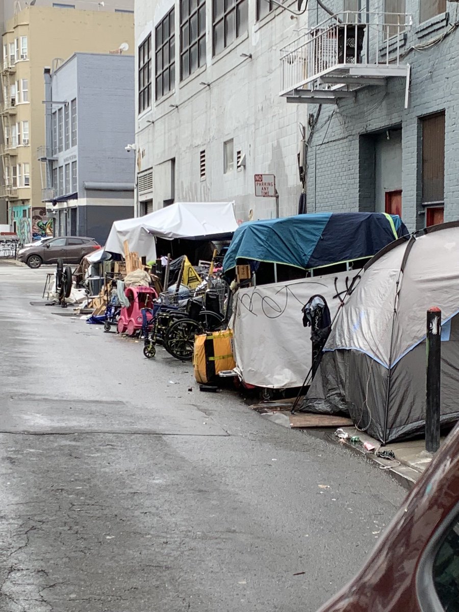 MM524's tweet image. This is the situation on Stevenson St. between Gough and Brady. The cars can barely drive by without hitting any of the “belongings” of the several homeless residents. @LondonBreed @MattHaneySF @mattdorsey @SFPD @SF311 @Scott_Wiener