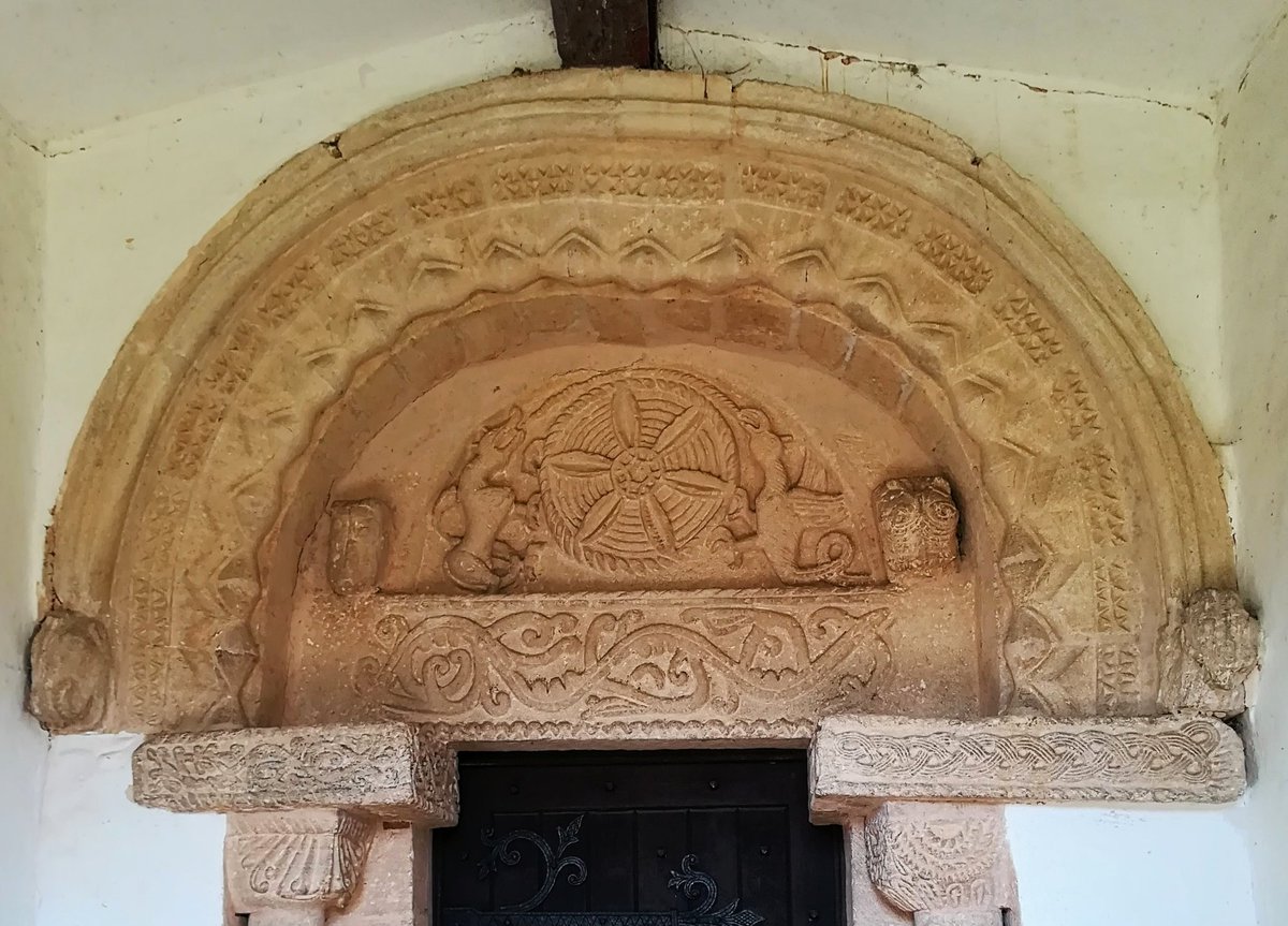 The fantastic 12thC tympanum at St Edmund's, Egleton is full of character.  Two winged creatures (possibly a wyvern and a dragon) support a flower like wheel with horned beastie heads either side.  
#TympanumTuesday