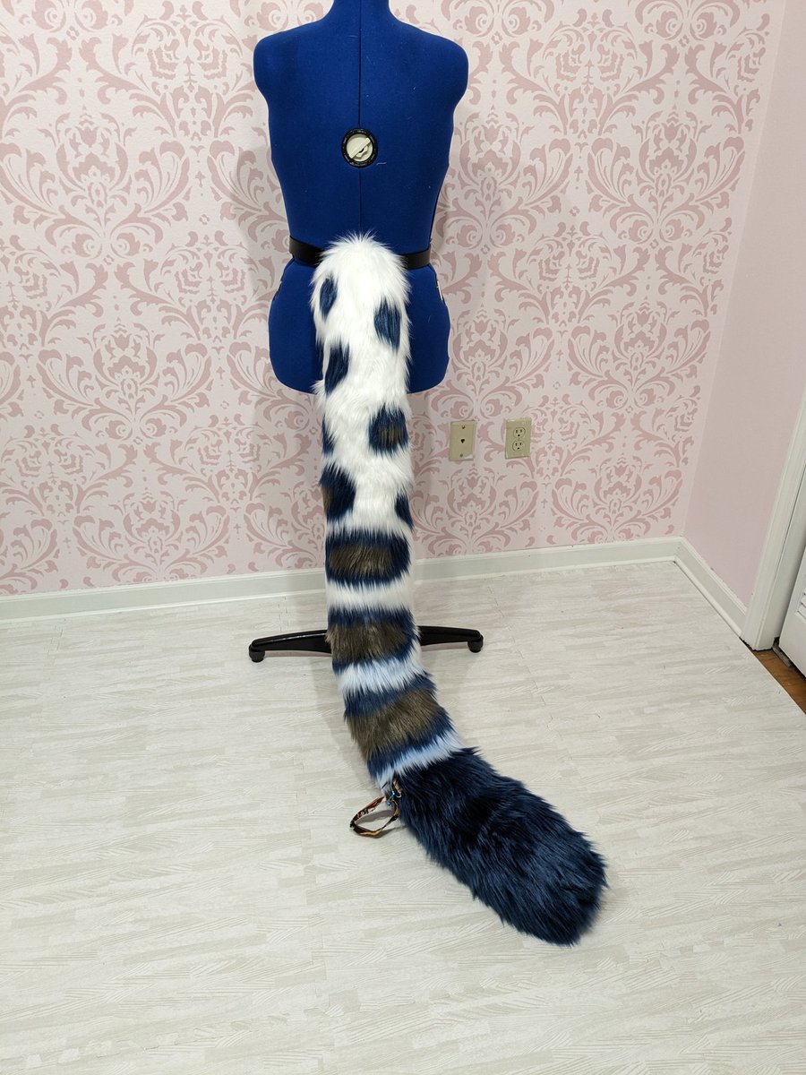 5 foot long snow leopard tail for Channy's partial! Modeled by my dressform, Edith. Loved making this! It's got a d ring for a removable wrist strap as well :3 #fursuitmaker #Fursuit