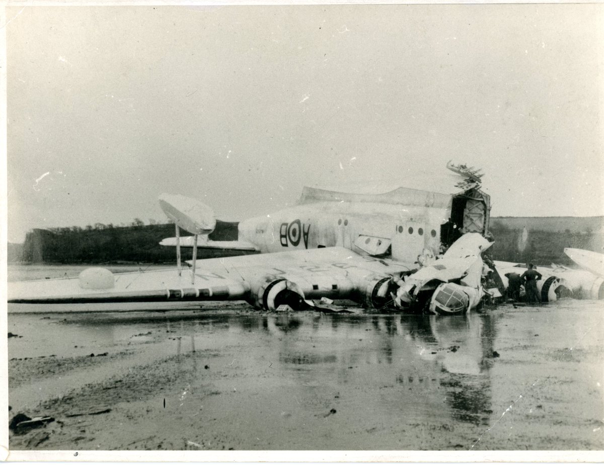 The tragic sight of Short Sunderland (NJ267) which crashed off Angle Bay on March 3rd 1954. 
Sadly seven crew on board the aircraft perished in the crash, this image shows the remains of the aircraft ashore on the beach at Angle, awaiting investigation and possible salvage.