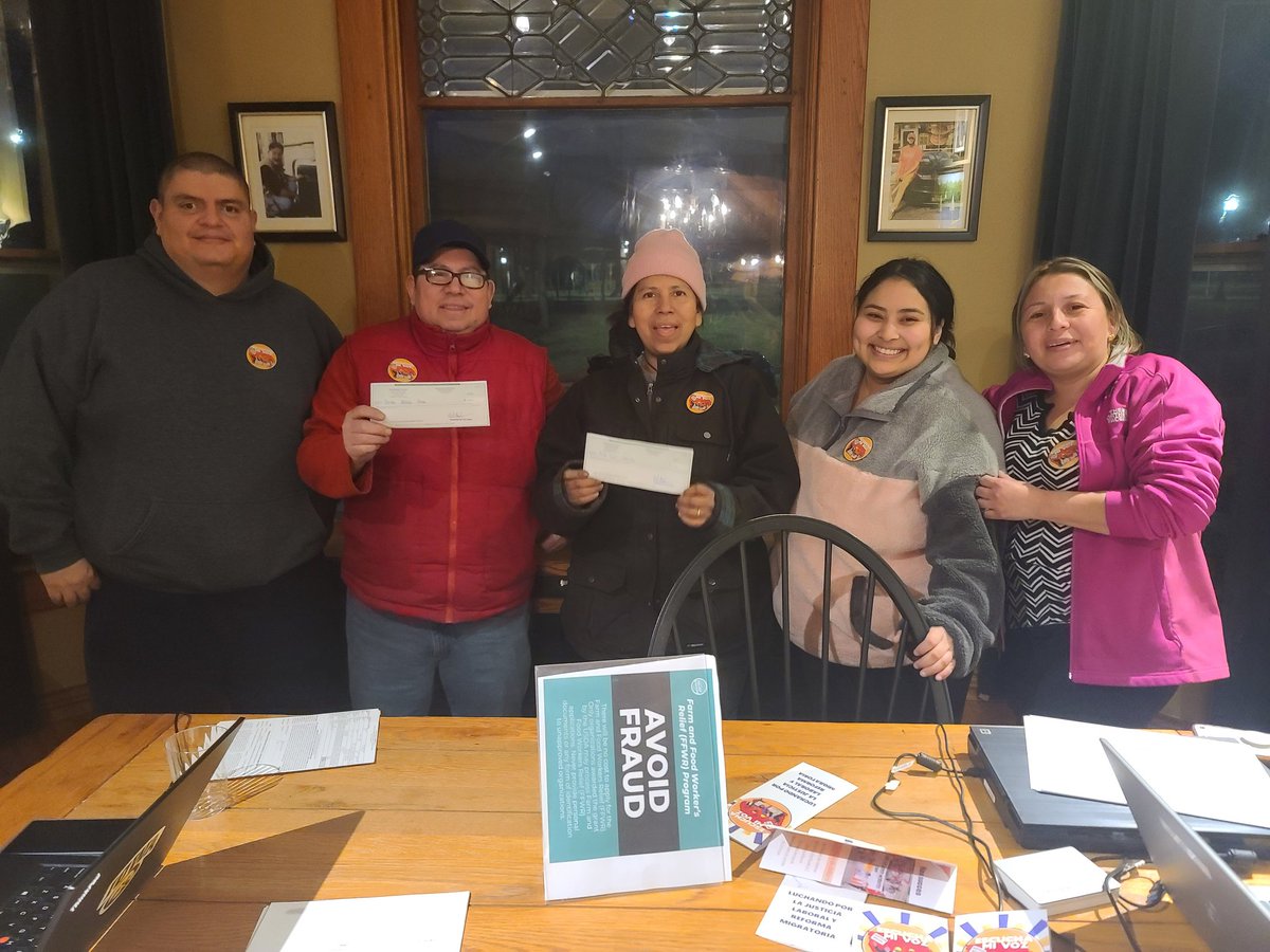 Farmworkers and Escucha Mi Voz members Benito Sosa and Nila Cruz of Washington, Iowa pose for a picture with group members Ninsoka Campos, Naomi Marroquin, and Horacio Bautista after receiving their $600 Farm and Food Workers Relief program checks today in Iowa City, Iowa