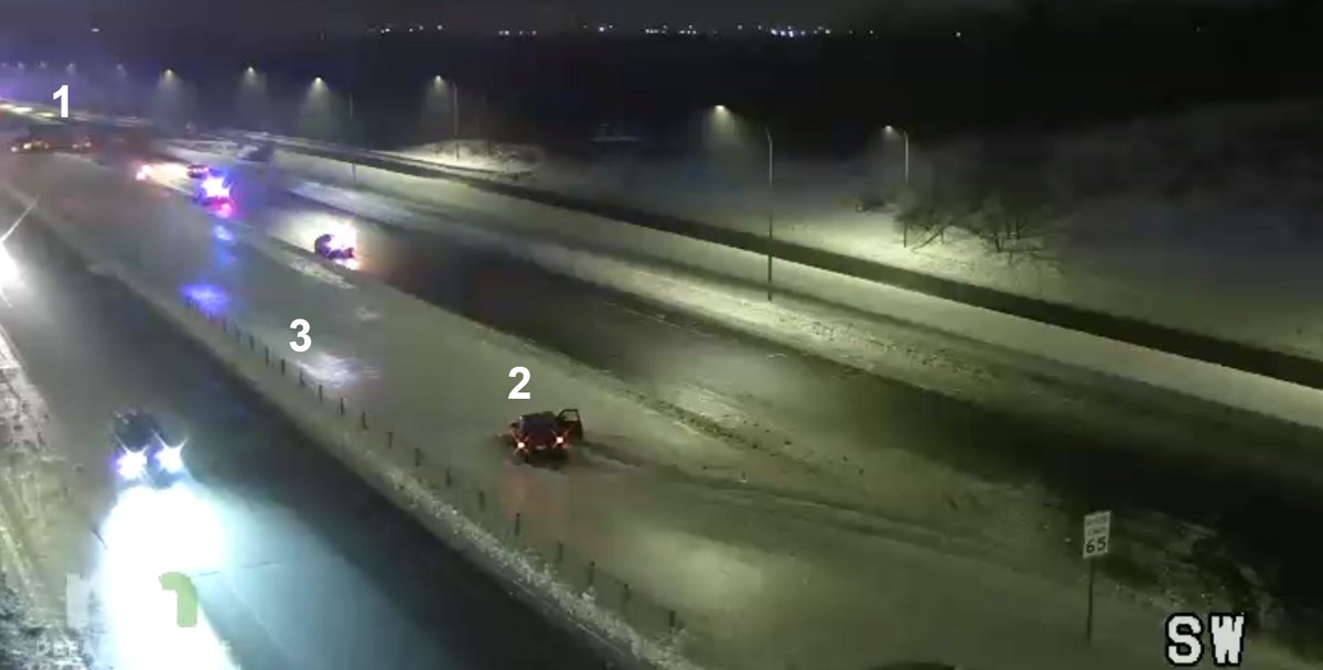 NWSTwinCities's tweet photo. This capture of the approach to the Bloomington Ferry Bridge from Shakopee shows how dicey it is out there this morning. This camera has:

1) Jackknifed semi
2) Slide off
3) Reflection of lights in snow showing the ice glaze developing. 

SLOW DOWN if driving this morning! #mnwx https://t.co/xEPtjLNmw8