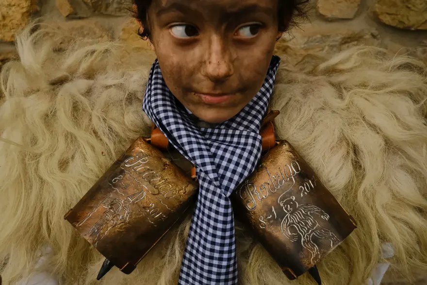 Silió, Spain - A boy dressed in sheepskins and bells, part of the carnival group La Vijanera de Silió, takes part in a traditional ancient festival in the town