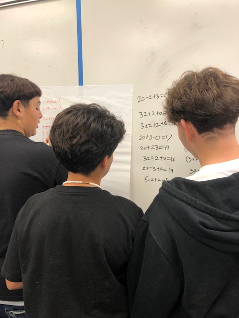 BrittonClass's tweet image. Vertical learning structure for a team challenge in Mr. Q's class. How many different equations can you create with the numbers 2023 that equals numbers 1-50 as answers? @BurtonBulldogs @BurtonSchools #Engage #ThinkCreatively