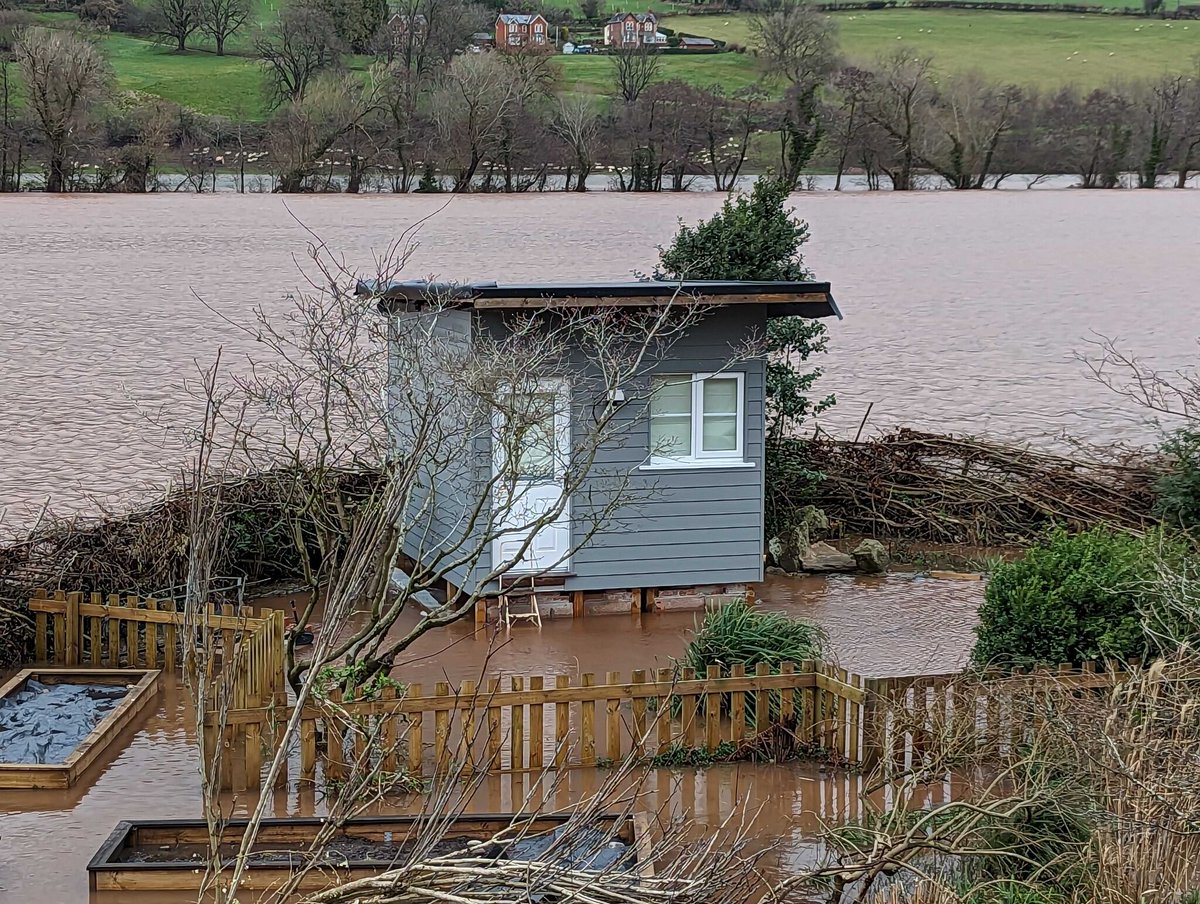 DiviEngine's tweet photo. Debugging just got a whole lot wetter. Yes, that is Peter's office. No, that river/lake is not normally there. #WorkFromHome #DiviEngine #WalesWeather" https://t.co/JPT9Ux2OvA