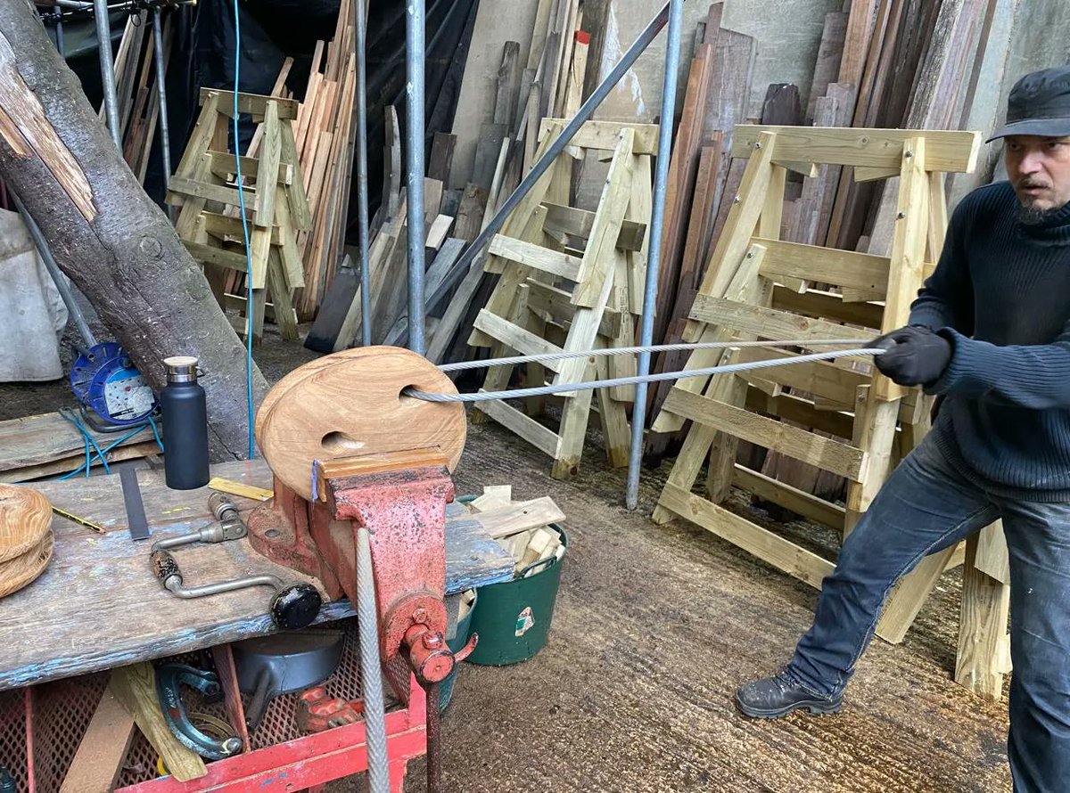 GoldenHinde_'s tweet image. Refit Update: Dead eyes are an integral part of the ship’s rigging. The dead eyes are currently being re-shaped and smoothed. To do this, the shipwrights are using the ‘garrote’ method to form the shape of the hole. Two days till work begins on the rigging. #refit #shipwright