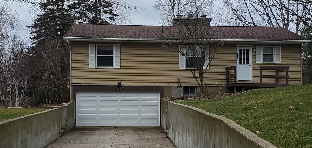 Our house with the new garage and front doors. Mom no longer has to struggle with those hideous and horrific old crappy doors anymore. 😺👍