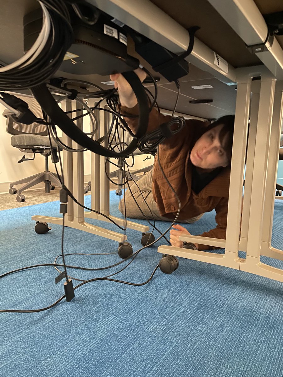 BeckyBingUT's tweet photo. My colleague Maren working to get power back to our conference room equipment for a hybrid in-person/virtual meeting today @UofUHealth #MarCom #otherdutiesasassigned #jobtobedone https://t.co/TQ8QxjuEZE