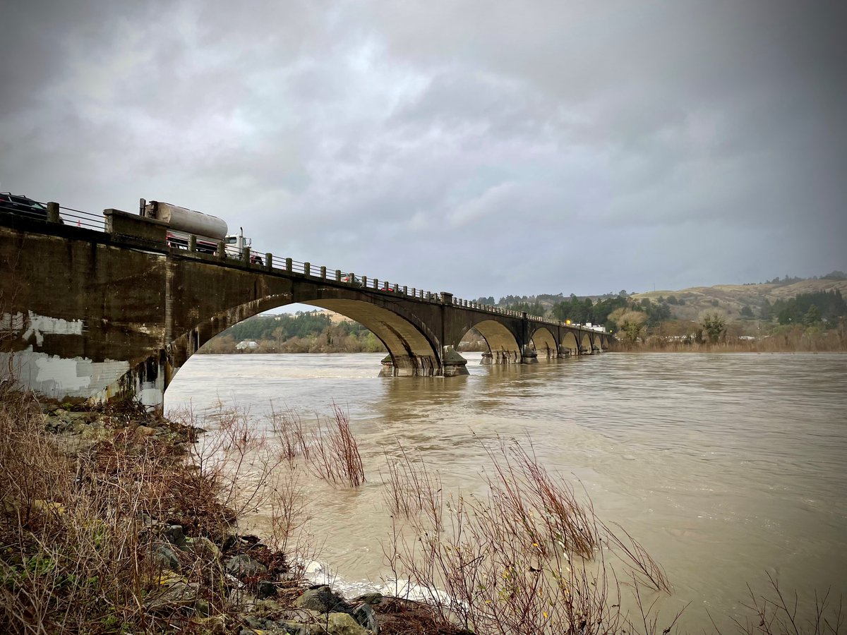 CaltransDist1's tweet photo. Fernbridge/#Route211 users: We continue to closely monitor Fernbridge and the #EelRiver's height. The current weather forecast suggests we may be able to keep the bridge open through this storm. Follow for updates. Visit https://t.co/faudYOtp7p for road conditions. @CaltransHQ https://t.co/PJuuGdoZkl