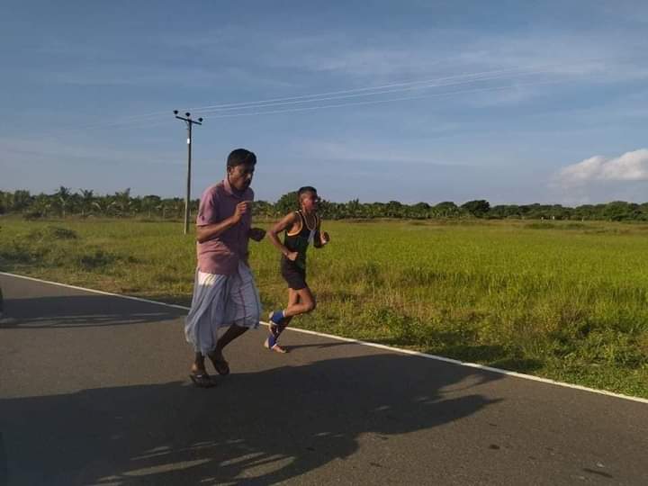 Vinojana9's tweet photo. There was an incident where the father ran to the finish line with his son who won the 1st place in the marathon race held today at Mannar Silawathurai.
Yusuf Irfan is an ordinary poor fisherman. It is an expression of a father's desire for his son to reach the top.

 📷 -Irfan https://t.co/BI8Fz54jNt