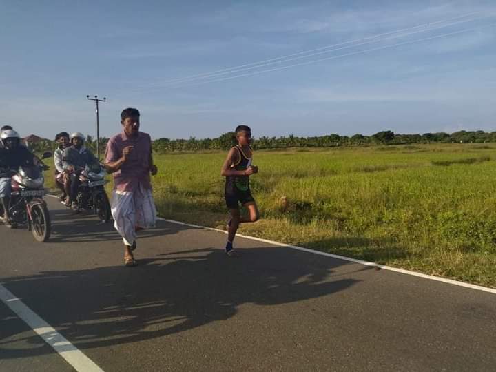Vinojana9's tweet photo. There was an incident where the father ran to the finish line with his son who won the 1st place in the marathon race held today at Mannar Silawathurai.
Yusuf Irfan is an ordinary poor fisherman. It is an expression of a father's desire for his son to reach the top.

 📷 -Irfan https://t.co/BI8Fz54jNt