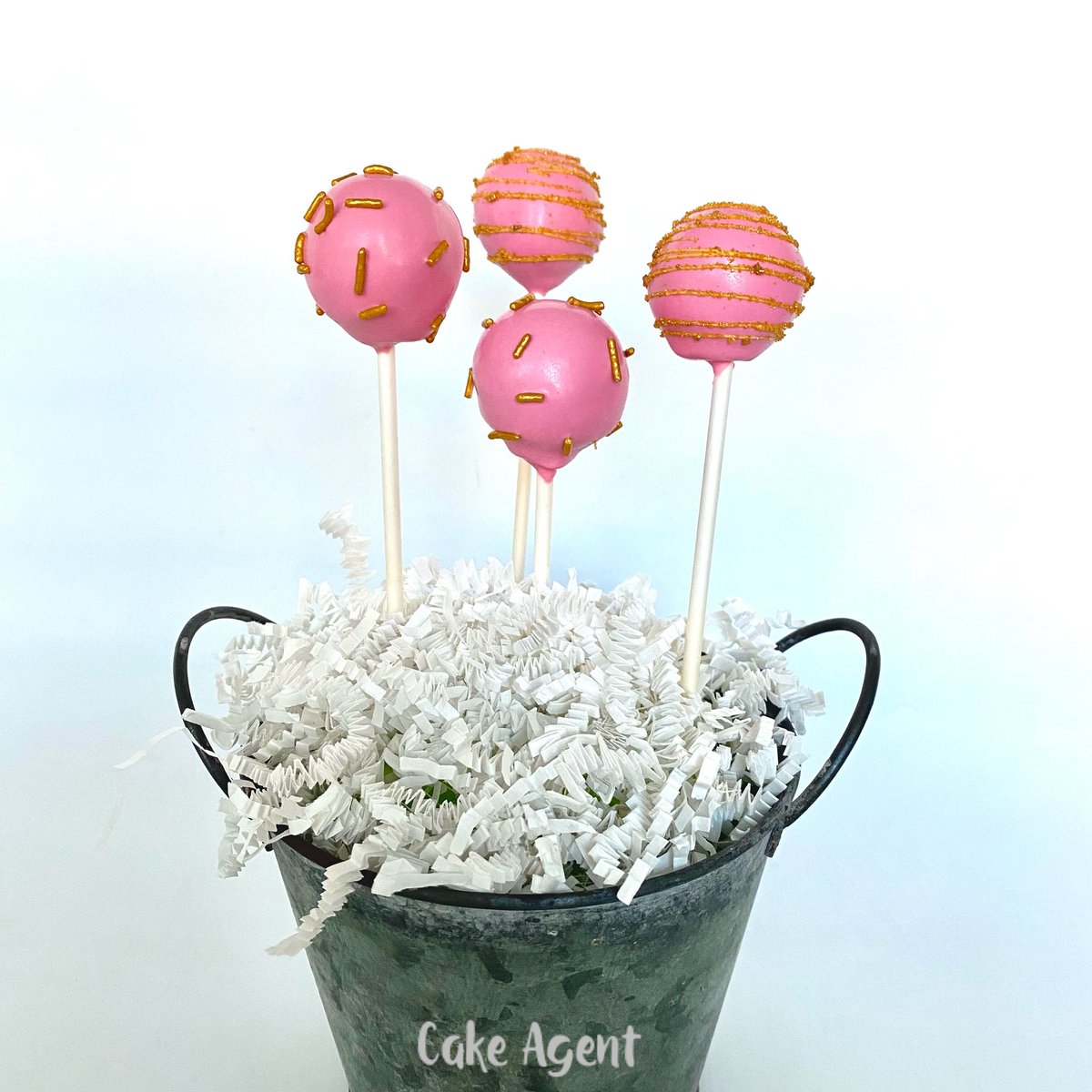 Easy DIY #cakepop stand. Use whatever container you want. Put floral foam inside container, insert #pops, and fill in with #crinklepaper #cakeagent