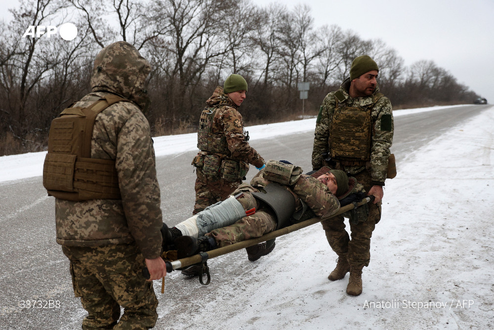 Bloodied helmets and body armor cut from dead soldiers are discarded on a roadside leading to the old mining town of Soledar, but the Ukrainian medics waiting there stay focused on those they can save.

u.afp.com/iQBa
 by <a href="/SusannahWalden/">Susannah Walden</a>