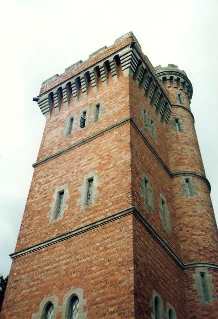 Tower about 100 metres
east of Rous Lench Court

Tower. c1860's - 1870's, by Dr W K W Chafy. Brick with ashlar dressings.
Square plan, with circular stair turret at north-east corner. Italianate
style. Four storeys with crenellated parapet on machicolations.