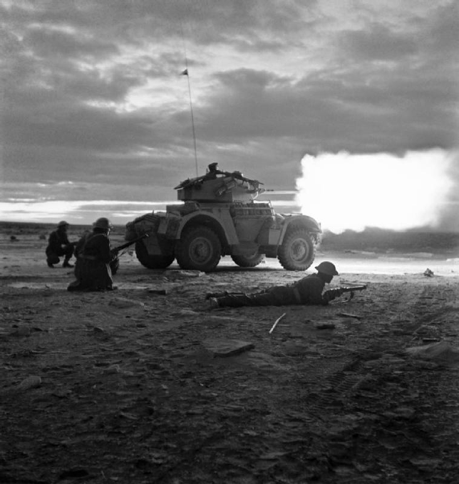 Courtesy of Imperial War Museums © IWM E 21333 "The British Army in North Africa, 1943" A Daimler armoured car opens fire in the gloom of early morning at the start of the battle for Tripoli, 18 January 1943.