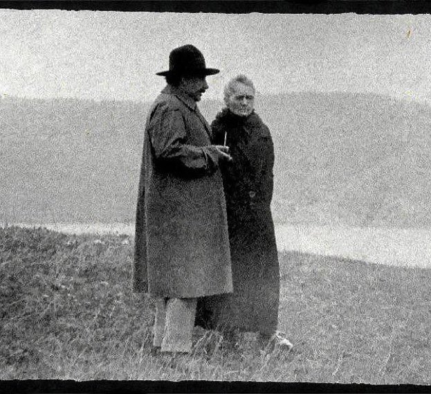 Albert Einstein and Marie Curie discussing near a lake, c. 1929