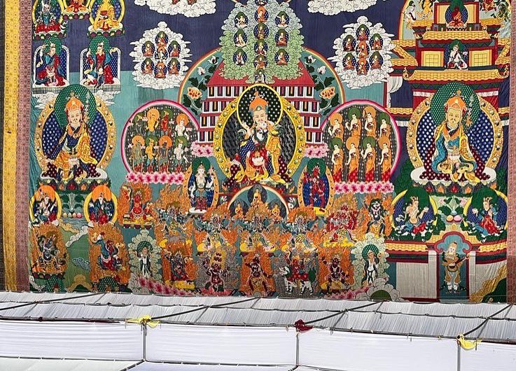 LamaZopa's tweet photo. The 100,000 tsog offering puja to Padmasambhava is being offered in front of a gigantic Padmasambhava thangka. This thangka, stitched in appliqué and is 75 feet high &amp; 87 feet wide. It took 2 years to create &amp; was completed in 2013 &amp; blessed by His Holiness the Dalai Lama. https://t.co/ZtJQO16uML