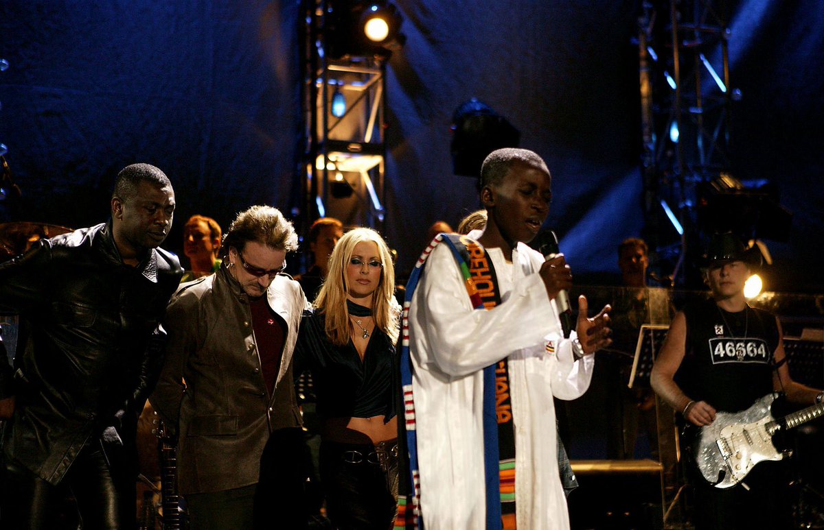 wearehomeland's tweet photo. November 29, 2003 - Andrews Bonsu, a 14 year-old preacher from Ghana, speaks at Nelson Mandela’s “46664 - Give One Minute of Your Life to AIDS” concert at Greenpoint Stadium in Cape Town, South Africa. https://t.co/uGSEcjKJfI