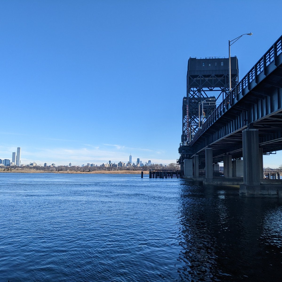 Skyline of Jersey City and Manhattan from under the 1-9 bridge on the Hackensack River