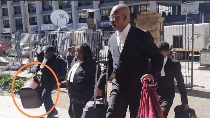 AdvoBarryRoux's tweet image. What is the man on the far left carrying?