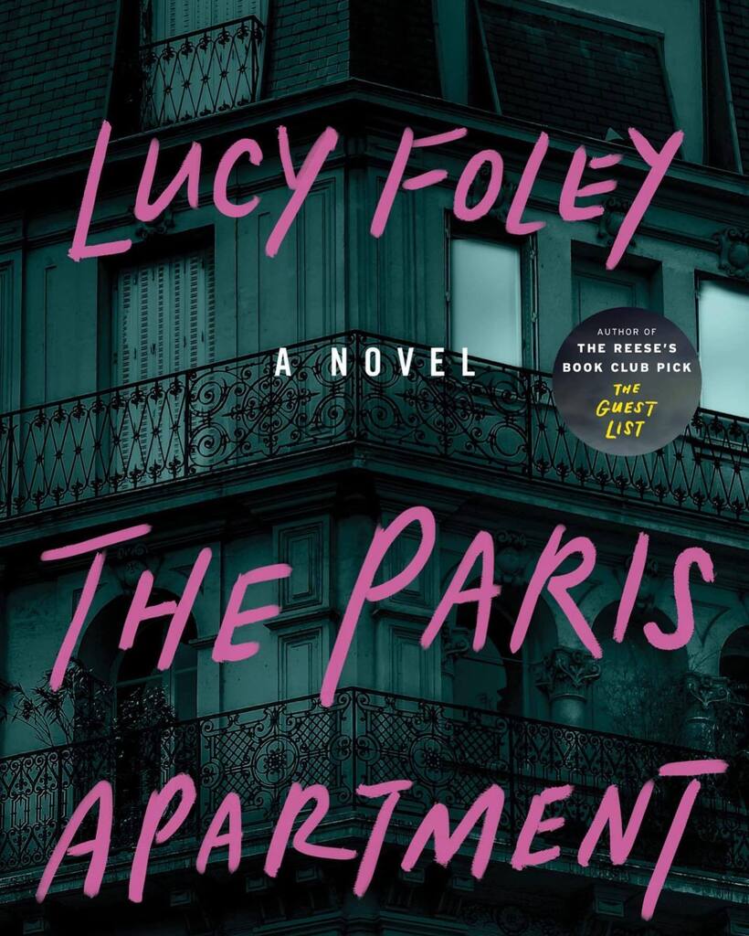 F, 30s, rose-tinted sunglasses, black top, beige scarf, reading at an inside table by the window in the morning sun, Sook Pastry, Ridgewood NJ #TheParisApartment #LucyFoley #AgentTouchdown #CoverSpyNYMetroArea instagr.am/p/Cnhm90ervt4/