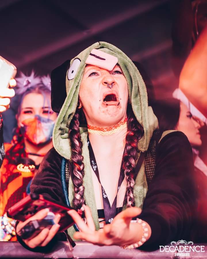 lion6895's tweet photo. OH MY...... GOD I did not expect this to ever happen to me but Decadence AZ just posted this pic of my bass face during Midnight Tyrannosaurus set and yes im wearing a gir onesie 🦖🥲😭 #lostlandsfam #bassface #wookery #edmfamily #dubstep #invaderzim https://t.co/uwWW8mnwwG