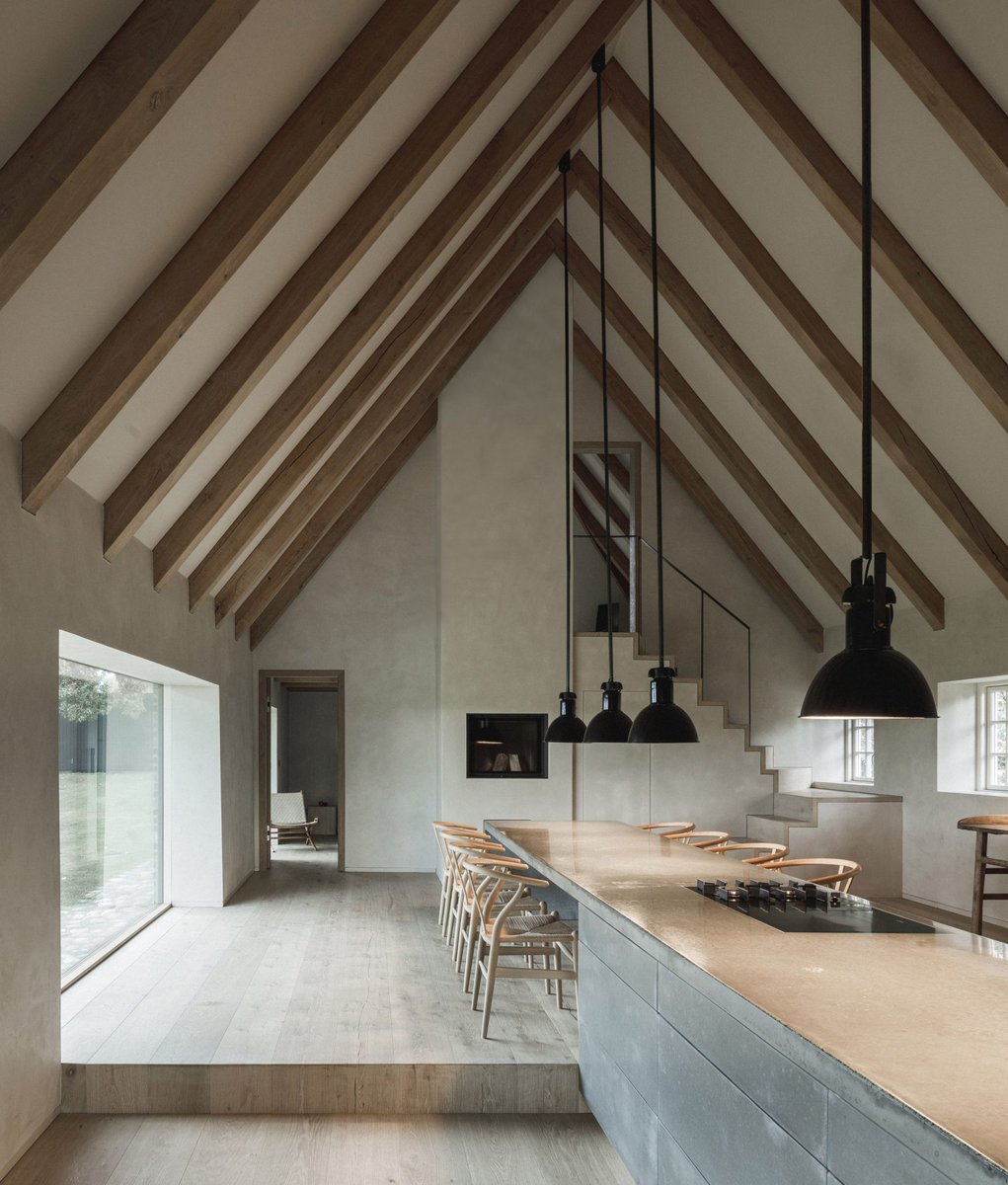 Glazed living room features in reconstruction of thatched Nieby Crofters Cottage: dezeen.com/2022/10/17/tha…