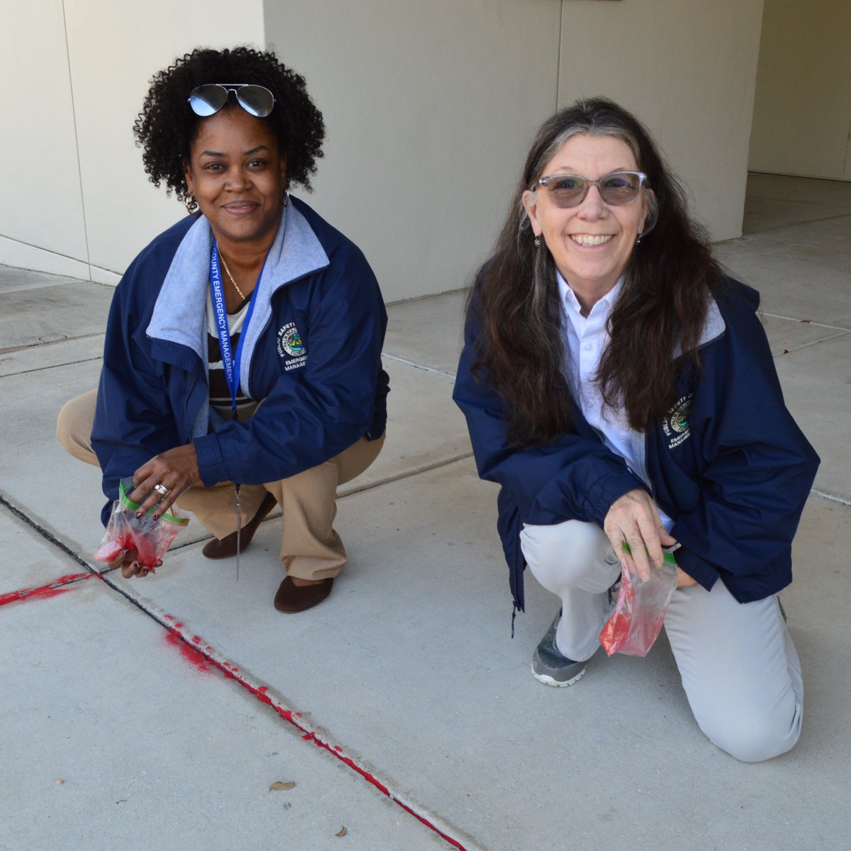 PBCOEM's tweet photo. Our TEAM participated in the #RedSandProject for #HumanTraffickingAwareness. We filled sidewalk cracks outside the Emergency Operations Center with red sand to highlight the ways people are vulnerable to exploitation. #PBSO #PBCVS https://t.co/FXlz1ToCqN